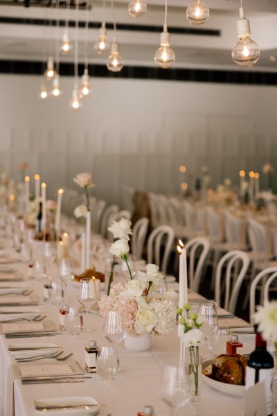 A table set with flowers, candles, glassware and table ware
