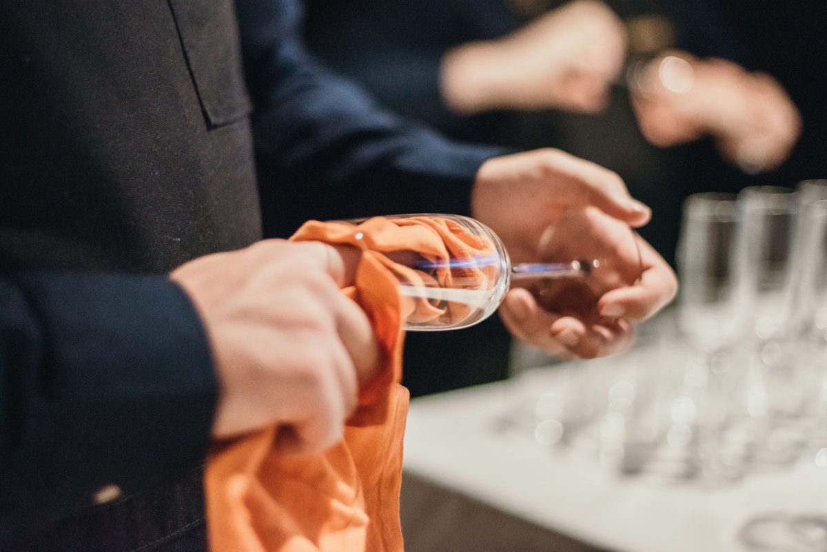 Waiter polishing a champagne glass