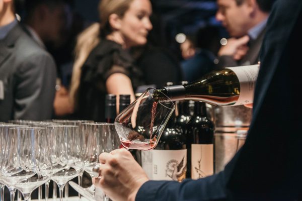 Waiter pouring red wine