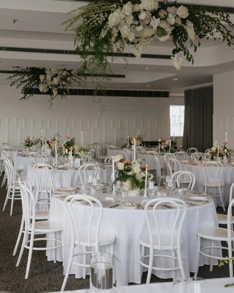 Round tables with flowers, candles and glasses